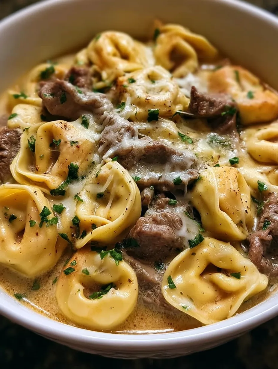 Un plato de tortellini estilo cheesesteak en salsa cremosa de provolone.
