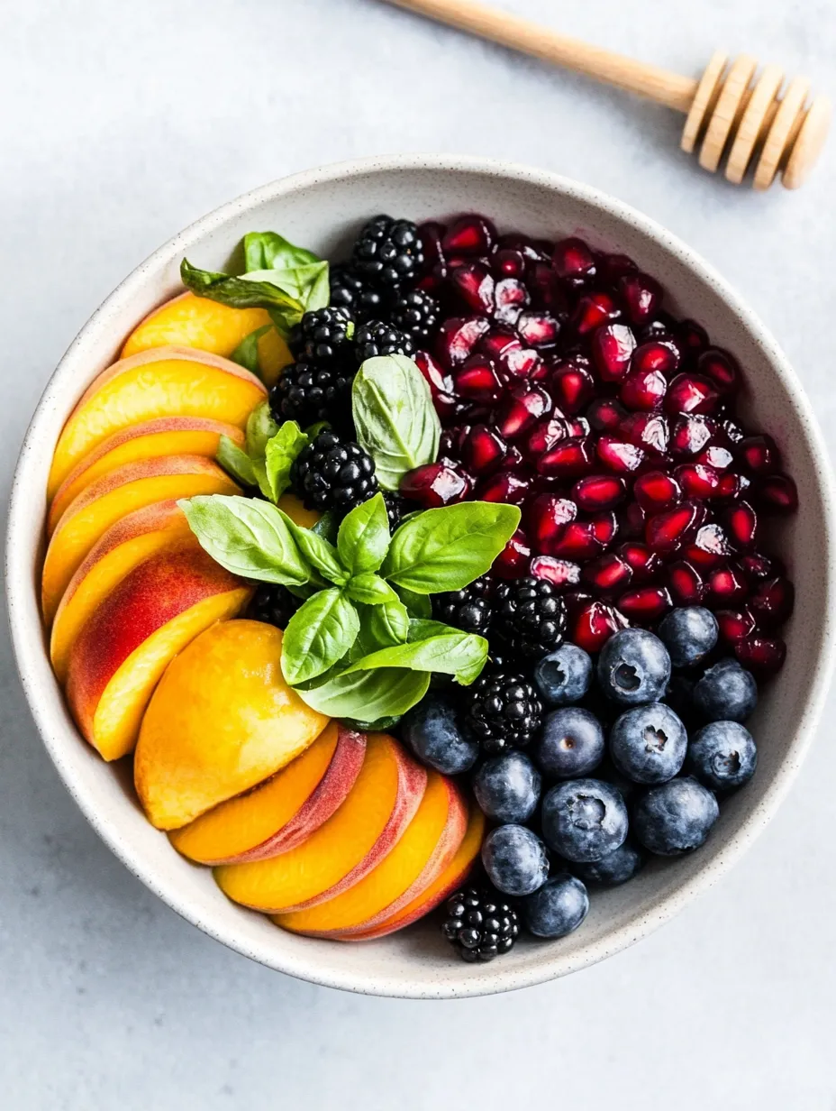 Un bol de fruta con arándanos, frambuesas, melocotones y moras.
