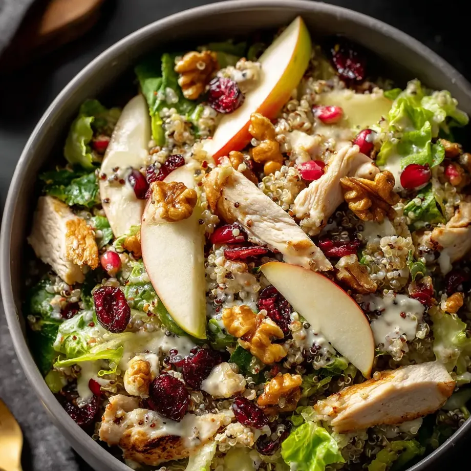 Un bowl grande y oscuro lleno de verdura fresca, nueces y hojas verdes.