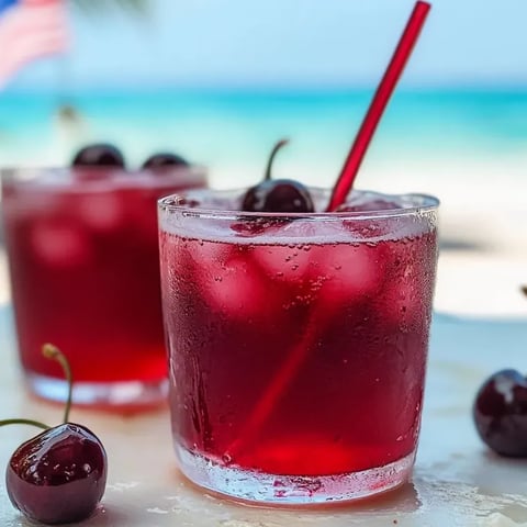 Un vaso de refresco burbujeante de cereza y vainilla.